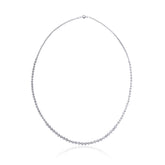 A long silver beaded necklace twisted three times with a graduated design, featuring varying sphere sizes. Can be worn twisted in three different ways  for a layered look or untwisted for a sleek, minimal style.