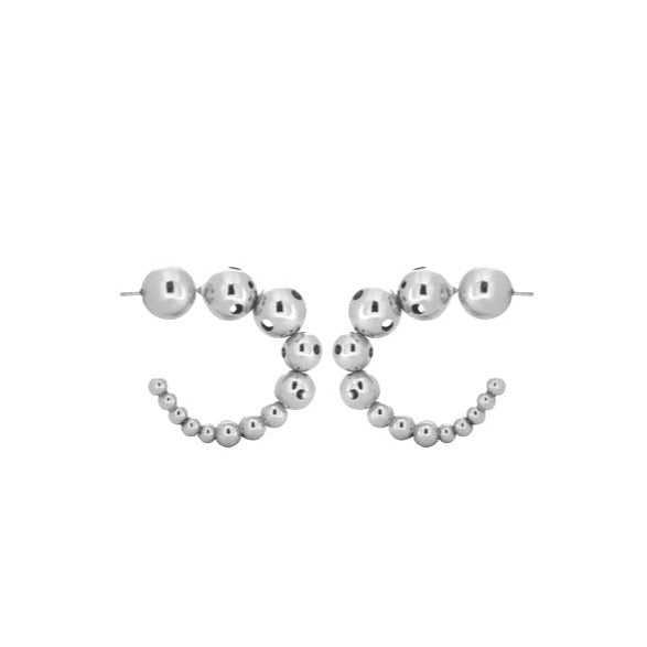 Pair of small silver earrings featuring a curved design made of graduated metallic spheres.